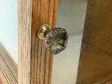 a close up of a glass door with a knob on it