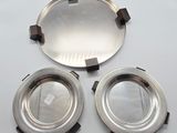 two silver plates and a silver tray on a white surface