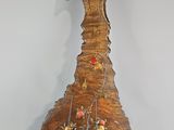 a wooden sculpture of a bird with flowers on it ' s head