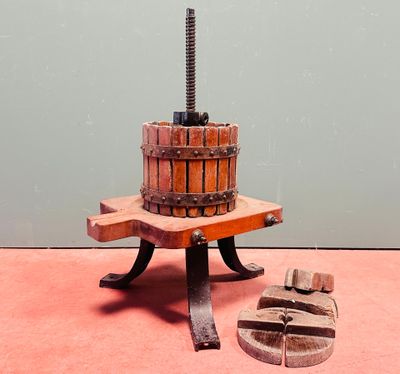 une photo d'une machine à fabriquer des blocs de bois posée sur un fond rose