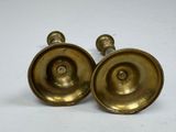 pair of antique brass candlesticks on a white background