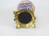 a gold vase with a blue and orange design on it