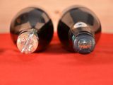 two bottles of wine that are sitting on a table