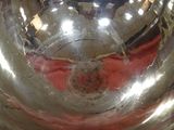 a shiny silver bowl with a red cloth underneath it