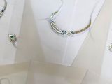 many different types of jewelry displayed in a display case