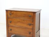 an old wooden chest of drawers sitting on top of a white floor