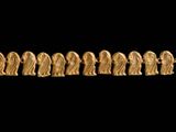 a close up of a gold necklace on a black background