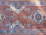 an old persian rug with a blue and red design on it