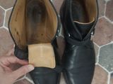 a person that is putting something in a pair of shoes