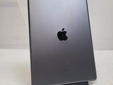 an apple ipad is sitting on a stand on a white surface