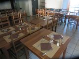 tables and chairs in a restaurant with place mats and placemats on them