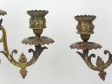 pair of antique brass candelabs with flowers on each of them