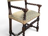 an old wooden chair with a green upholstered seat
