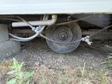 a close up of a truck ' s tire with a hose attached to it