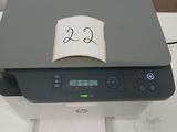 a printer sitting on top of a desk with a note taped to it