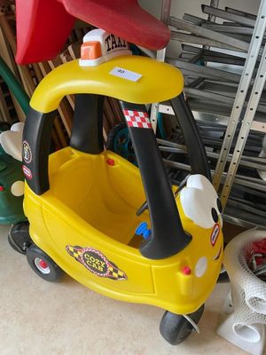 a small yellow toy car with a red hat on top of it