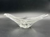 clear glass bowl sitting on top of a table with a black background