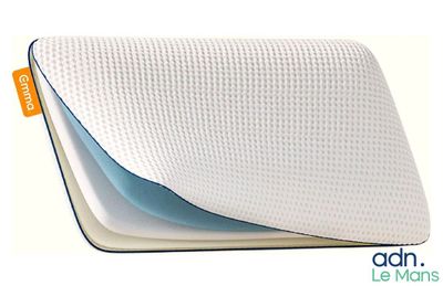 a close up of a pillow on a white surface