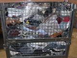 a metal cart filled with lots of items inside of a warehouse
