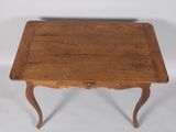 an old wooden table with a drawer underneath it on a white surface