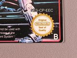 a game card with a picture of a person holding a gun
