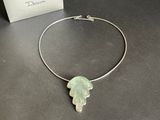 silver plated necklace with a green leaf pendant on it