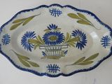 a blue and green plate with flowers on it