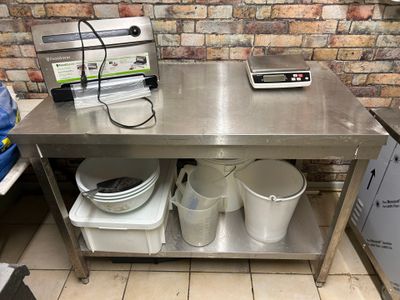 a metal table with buckets and a phone on it