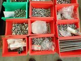 many different types of screws and nuts in the bins