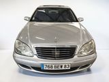 a silver car that is parked in a white room