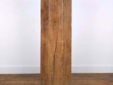 an old wooden column sitting on top of a hard wood floor