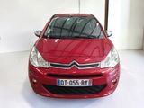 the front of a red citrole car parked in a garage