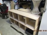 a wooden shelf that has a lamp on top of it