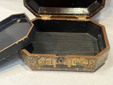 a black and gold box sitting on a white table