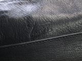 the inside of a black leather purse with a zipper on it