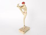wooden figurine of a baseball player with a bat on a base