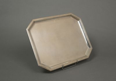 an antique silver tray with a mirror on top of it