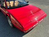 a red sports car parked in a parking lot