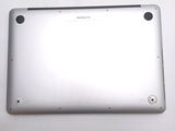 the back of a silver tablet computer sitting on top of a white table