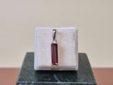 sterling silver and garnetite pendant on a marble block