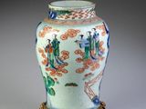a vase that is sitting on a stand on a table