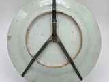 a white plate with a clock on it on a table