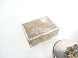 a silver box sitting next to a silver box on a white surface