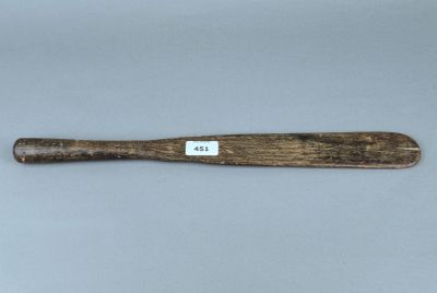 un gros plan d'une batte de baseball posée sur une table, avec une étiquette dessus