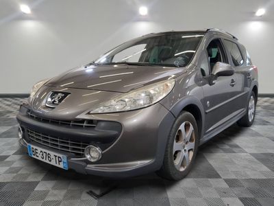 grey car parked on a checkered tile floor in a garage