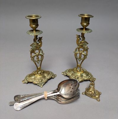 pair of antique brass candlesticks with spoon and spoon rest