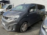 a grey van parked in a parking lot next to other cars