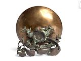 a bronze ball with a clock on top of it