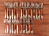 a set of six forks and a knife on a wooden table