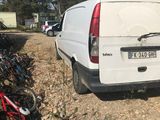 a van that is parked next to a bunch of bikes
